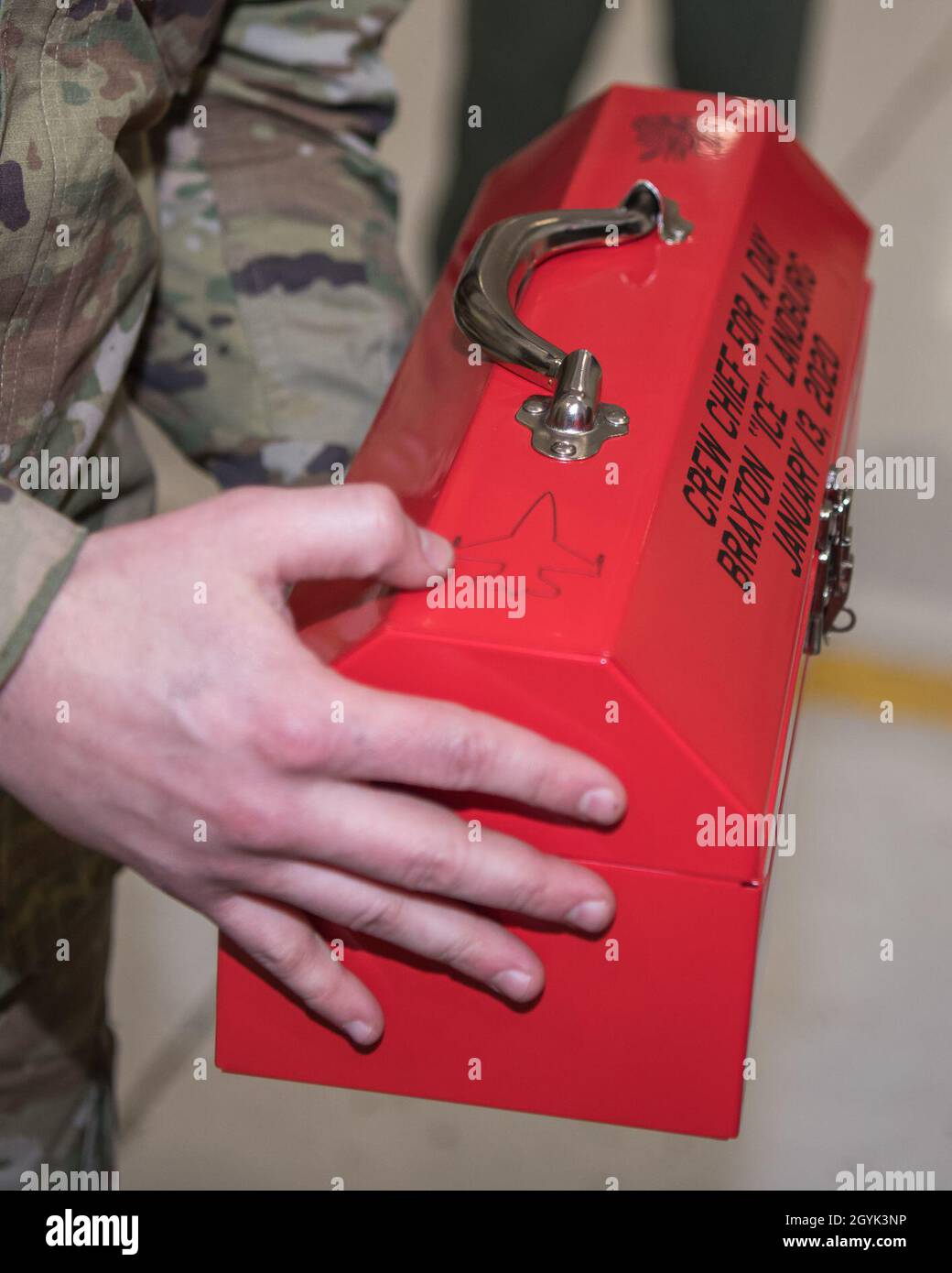 Staff Sgt. Jayson Mcknight, maintenance technician, 138th Fighter Wing, awards Braxton 'Ice' Landburg, Pilot For A Day, with his own tool box January 13, 2019 at Tulsa Air National Guard Base, Okla. The Pilot For A Day program allows children with potentially life threatening illnesses a chance to experience a day in the life of a Tulsa F-16 Pilot. (U.S. Air National Guard photo by Master Sgt. CT Michael) Stock Photo