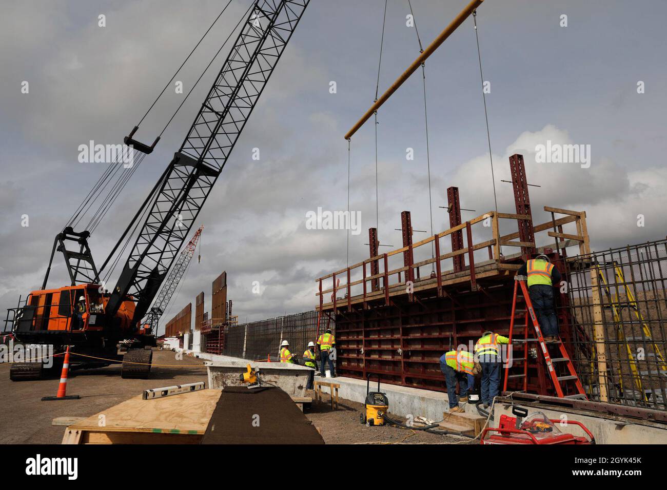 Construction crews work to erect levee wall system in a remote area south of Weslaco, Texas in