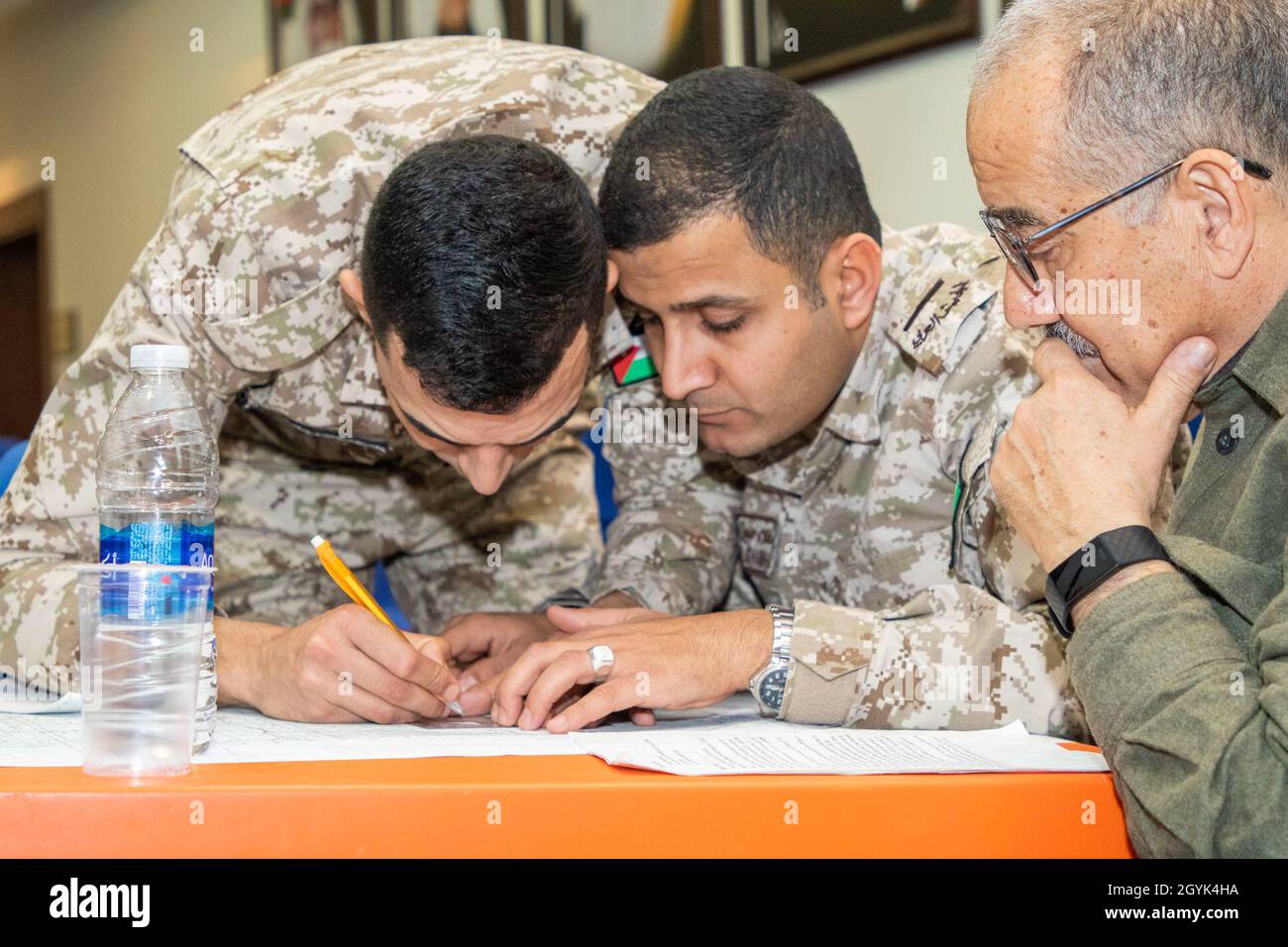 Jordan Armed Forces-Arab Army (JAF) Soldiers use a map protractor to plot points during a Map Reading Subject Matter Expert Exchange with Military Engagement Team-Jordan, 158th Maneuver Enhancement Brigade, Arizona Army National Guard, at a base outside of Amman, Jordan Jan. 13, 2020. The United States will protect our people and interests anywhere they are found around the world and is committed to the security of Jordan and to the partnering closely with the JAF to meet common security challenges. (U.S. Army photo by Sgt. 1st Class Shaiyla B. Hakeem) Stock Photo