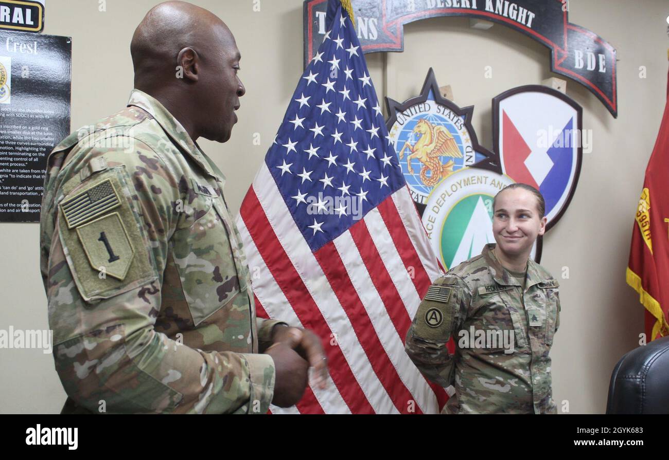 Col. Mondrey O. McLaurin, commander, 595th Transportation Brigade, congratulates Sgt. Ashlee S. Heckler, 840th Transportation Battalion, on her selection as Desert Knight of the month at Camp Arifjan, Kuwait, Jan. 14, 2020. (U.S. Army photo by Claudia LaMantia) Stock Photo