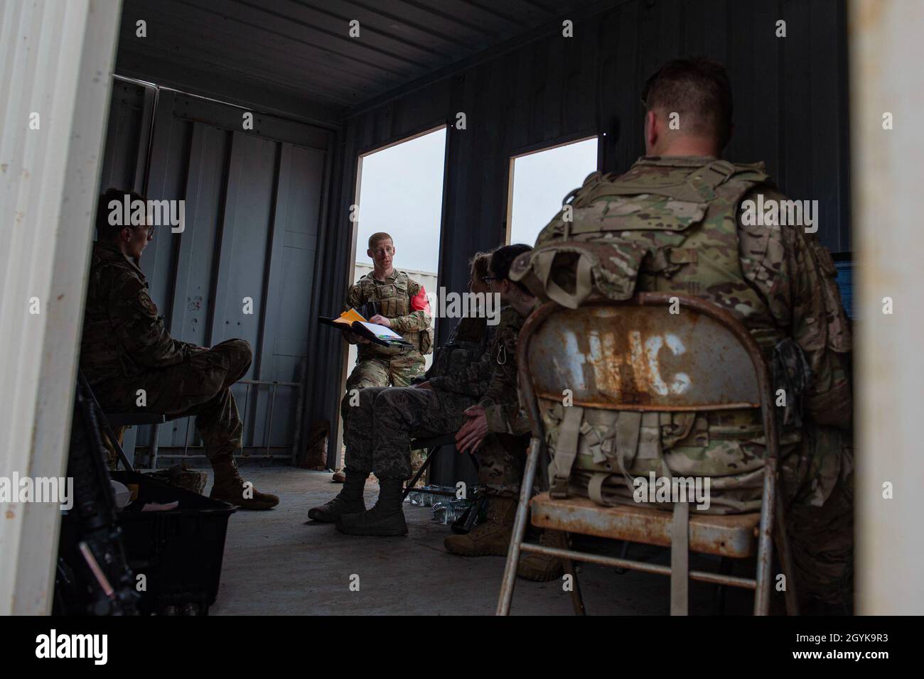 Airmen assigned to the 3d Weather Squadron debrief after a