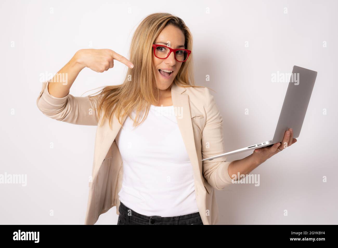 Portrait of a happy caucasian business woman working on laptop computer ...