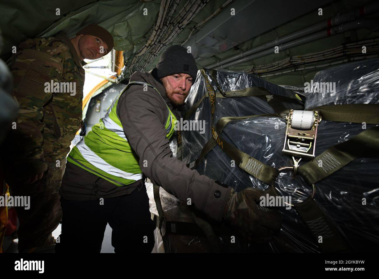 Christopher Reeve, 727th Air Mobility Squadron ramp operator, loads cargo onto a KC-135 Stratotanker during an annual cargo evaluation check ride at RAF Mildenhall, England, Jan. 16, 2020. The cargo check ride involves an inspection inside and outside the aircraft marking sure all loads are balanced and secured properly. (U.S. Air Force photo by Senior Airman Alexandria Lee) Stock Photo