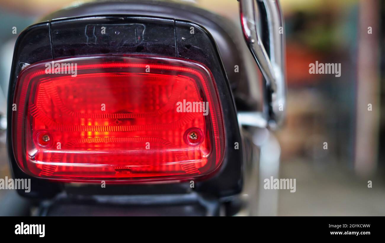 Stylish back light of a two wheeler. Picture of motorcycle red tail light. Stock Photo