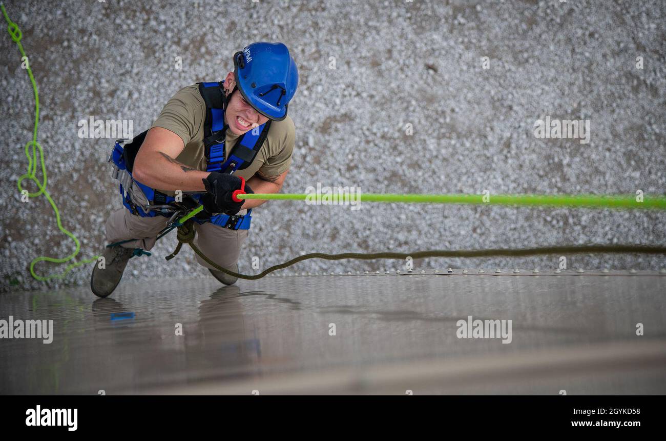 Airman 1st Class Zachary Belcher, 23rd Civil Engineer Squadron, practices ascending a four-story vertical wall as part of the rescue technician course Jan. 16 at Eglin Air Force Base, Fla.  The DOD Fire Academy course provided hands-on high elevation rescue, rappelling and moving in confined spaces training for 12 Air Force firefighters.  (U.S. Air Force photo/Samuel King Jr.) Stock Photo