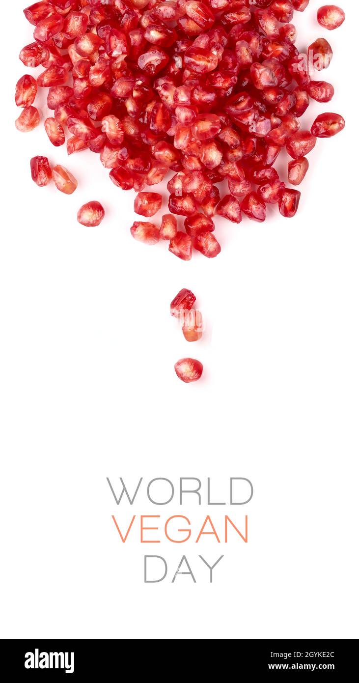 Vertical World Vegan Day design succulent healthy pomegranate seeds over a white background. World food day and vegetarian day concept Stock Photo