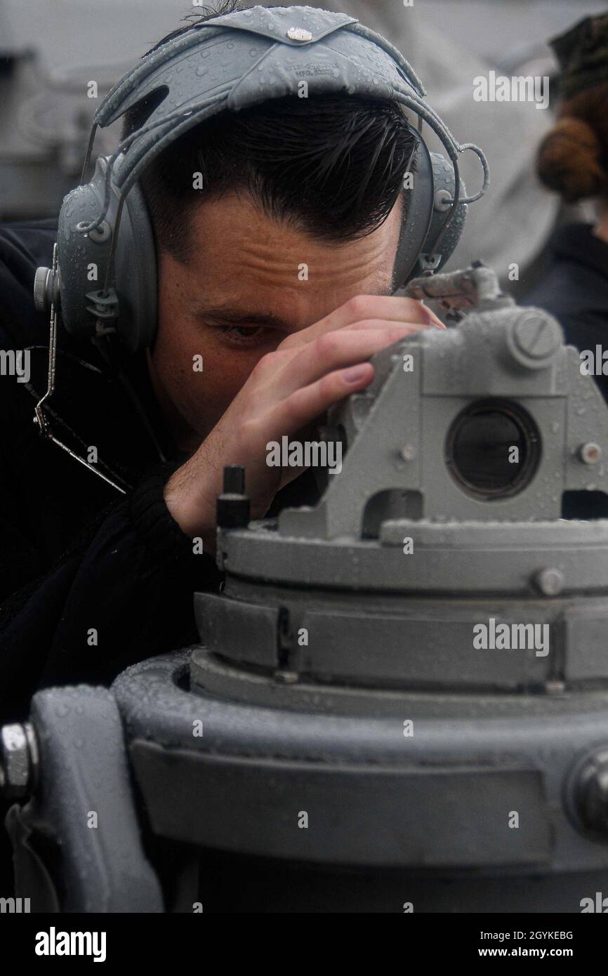 PACIFIC OCEAN (Jan. 17, 2020) Quartermaster 3rd Class Mathew Mahan, from San Diego, uses a telescopic alidade aboard the Arleigh Burke-class guided-missile destroyer USS Pinckney (DDG 91) Jan. 17, 2020. Pinckney, part of the Theodore Roosevelt Carrier Strike Group, is on a scheduled deployment to the Indo-Pacific. (U.S. Navy photo by Mass Communication Specialist 3rd Class Erick A. Parsons) Stock Photo