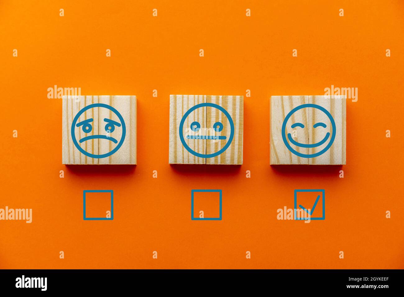 Orange background with emotion tiles and checkboxes for customer satisfaction surveys Stock Photo