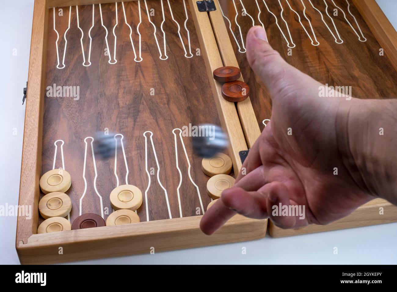 Moving dice hang in the air. Hand throws the dice on the background of