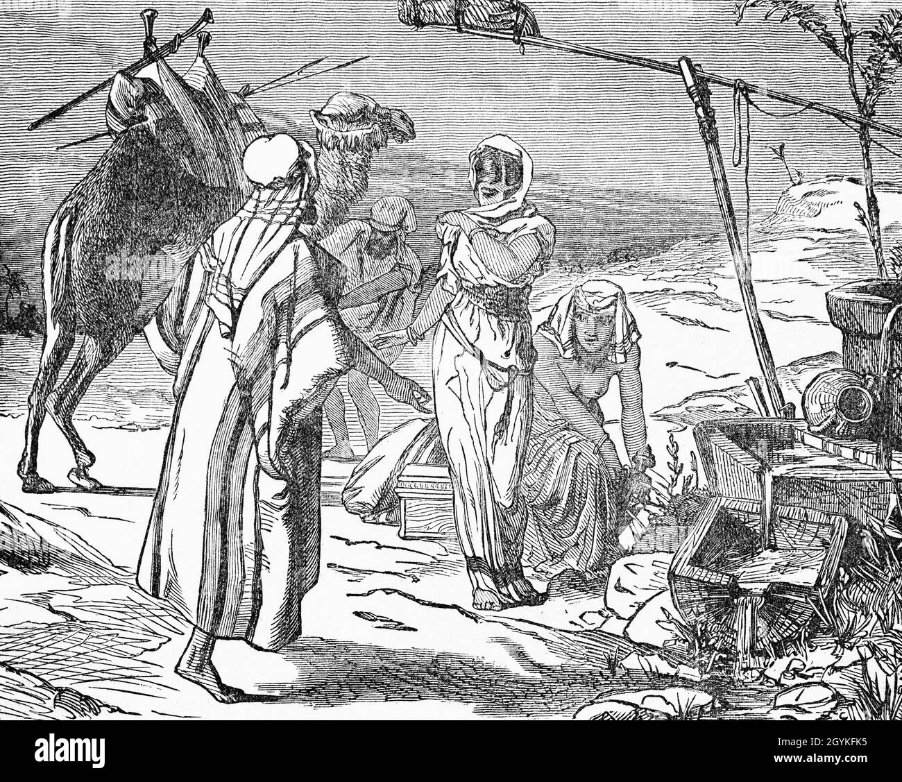 A late 19th Century illustration from the Book of Genesis of the meeting of the servant of Isaac, the son of Abraham and Sarah, and Rebekah, beautiful and from a good family.  Isaac and Rebekah would later marry and have two sons- Esau, father of the Edomites and the Amalekites, and Jacob, who would later be called Israel. Stock Photo