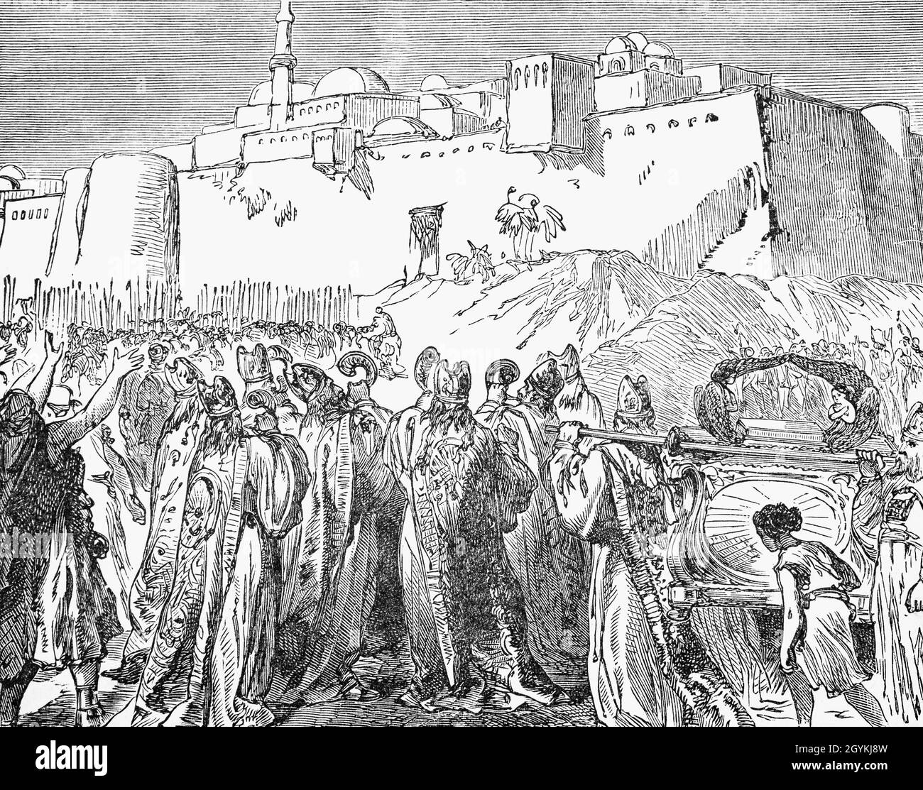 A late 19th Century illustration from the Book of Genesis of the fall of Jericho. The Israelites had entered the Promised Land and heir first battle was against the gateway city of Jericho using an unusual tactic. Priests were to carry the ark of the covenant, and seven priests, bearing seven trumpets of ram’s horns, blown continually. They circled the city once each day for six days and on the seventh day, march around the city seven times. After the seventh circuit, the priests were to make one long blast on the trumpets at which point the people shouted loudly and the wall fell down flat. Stock Photo