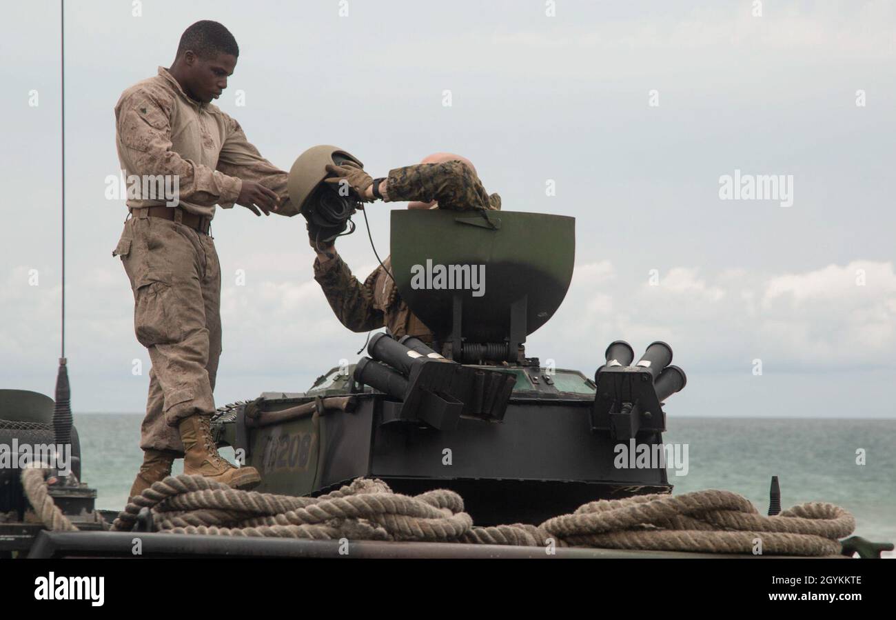 U.S. Marine Corps Cpl. Rakeem Shannon, a radio technician with 3rd Assault Amphibian Battalion, makes adjustments to an AAV-P7/A1 assault amphibious vehicle crew chief’s helmet before section-level beach landing training during Exercise Iron Fist 2020 on Marine Corps Base Camp Pendleton, California, Jan. 20. Exercises like Iron Fist enhance the Marine Corps ability to quickly deploy sea-based assets and provide military forces anywhere in the world. (U.S. Marine Corps photo by Sgt. Desiree King) Stock Photo