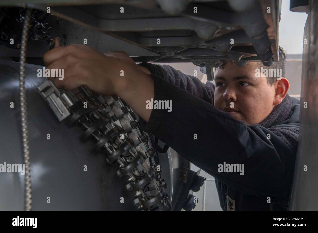 PACIFIC OCEAN (Jan. 21, 2020) Fire Controlman 2nd Class Oscar Mantillo, from Spokane, Wash., removes chuting and coiling elements from the Phalanx close-In weapon system (CIWS) aboard the Arleigh Burke-class guided-missile destroyer USS Paul Hamilton (DDG 60) Jan. 21, 2020. Paul Hamilton, part of the Theodore Roosevelt Carrier Strike Group, is on a scheduled deployment to the Indo-Pacific. (U.S. Navy photo by Mass Communication Specialist 3rd Class Matthew F. Jackson) Stock Photo