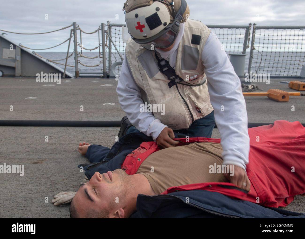 PACIFIC OCEAN (Jan. 21, 2020) Hospital Corpsman 3rd Class Lona Rachal, from Natchitoches, La., searches for simulated wounds on Damage Controlman 2nd Class Oscar Bernal, from San Jose, Calif., during a crash and salvage drill on the flight deck of the Arleigh Burke-class guided-missile destroyer USS Paul Hamilton (DDG 60) Jan. 21, 2020. Paul Hamilton, part of the Theodore Roosevelt Carrier Strike Group, is on a scheduled deployment to the Indo-Pacific. (U.S. Navy photo by Mass Communication Specialist 3rd Class Matthew F. Jackson) Stock Photo