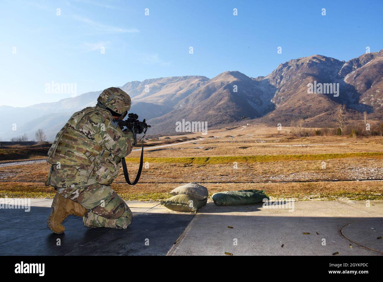 A U.S. Army Paratrooper assigned to the 173rd Airborne Brigade engages targets with an M4 carbine in kneeling position during weapons qualification at Cao Malnisio Range, Pordenone, Italy, Jan. 22, 2020. The 173rd Airborne Brigade is the U.S. Army Contingency Response Force in Europe, capable of projecting ready forces anywhere in the U.S. European, Africa or Central Commands' areas of responsibility. (U.S. Army photo by Paolo Bovo) Stock Photo