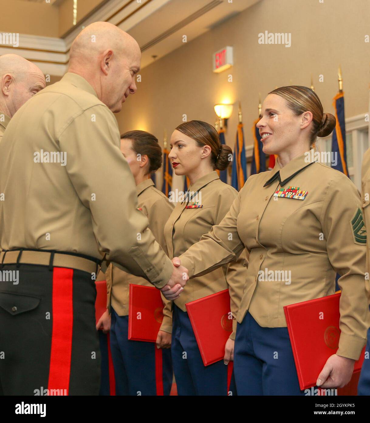 U.S. Marine Corps Gen. David H. Berger, Commandant of the Marine Corps, presents the Active Reserves Career Planner of the Year award to Gunnery Sgt. Kristina M. Perieff, career planner, Marine Aircraft Group 41, 4th Marine Aircraft Wing New Orleans, La., at the Commandant of the Marine Corps’ Combined Awards Ceremony at The Clubs at Quantico aboard Marine Corps Base Quantico, Va., Jan. 22, 2020. The ceremony recognizes commands with the highest combined physical and combat fitness performance, as well as top recruiters, instructors, athletes, and career planners around the Marine Corps. (U.S. Stock Photo