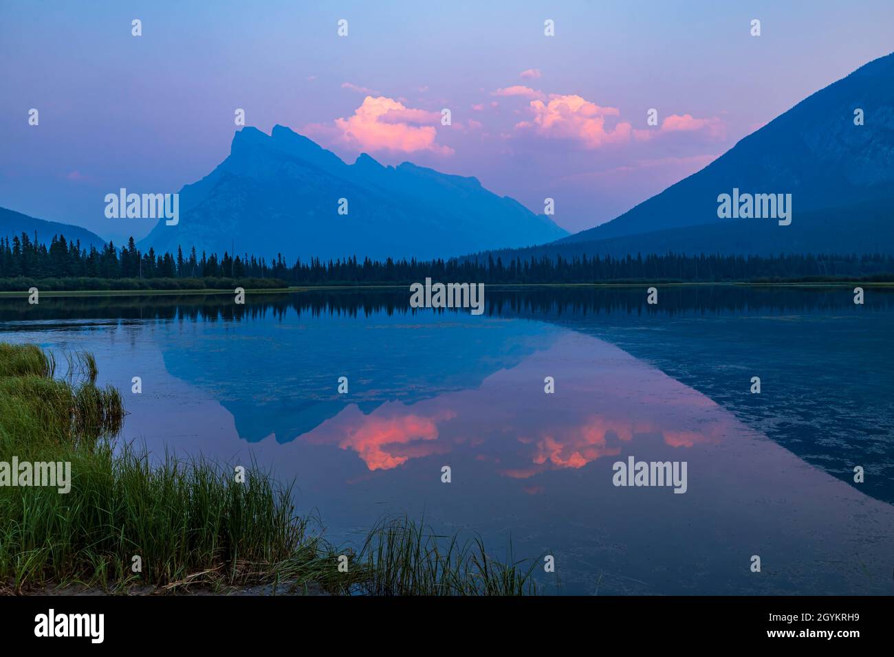 Sunset at Vermilion Lakes, Banff, Alberta, over Mt. Rundle reflected in the still waters, on an evening with a smoke-filled sky from B.C. forest fires Stock Photo