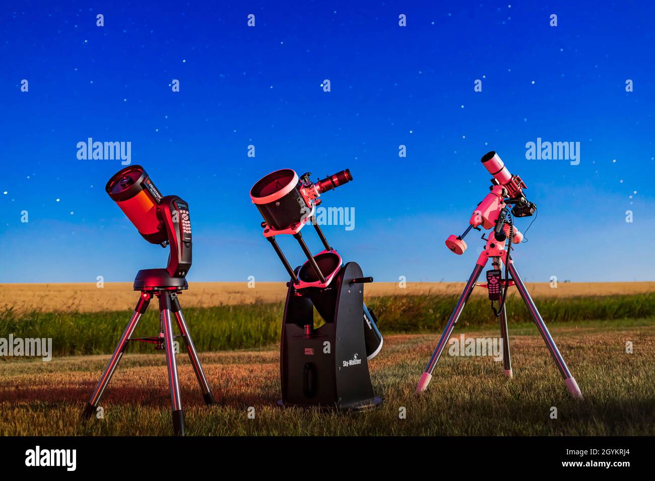 A trio of telescope types in moonlight: The Celestron NexStar 6SE Schmidt-Cassegrain, the Sky-Watcher 8-inch Flextube Dobsonian, and the SharpStar 76m Stock Photo