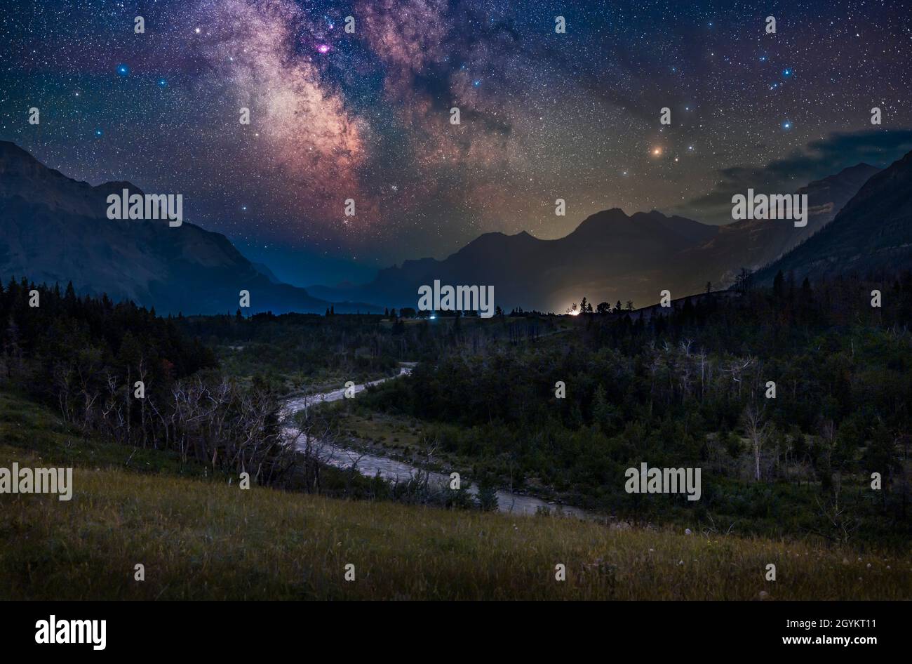The galactic core area of the northern summer Milky Way over the Blakiston Valley and Blakiston Creek in Waterton Lakes National Park, Alberta on a Ju Stock Photo