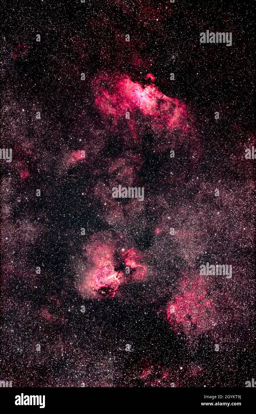 The Eagle Nebula at top (aka M16) and the Swan Nebula (aka M17), straddling the Serpens-Sagittarius border. The star cluster below M17 is M18, while t Stock Photo