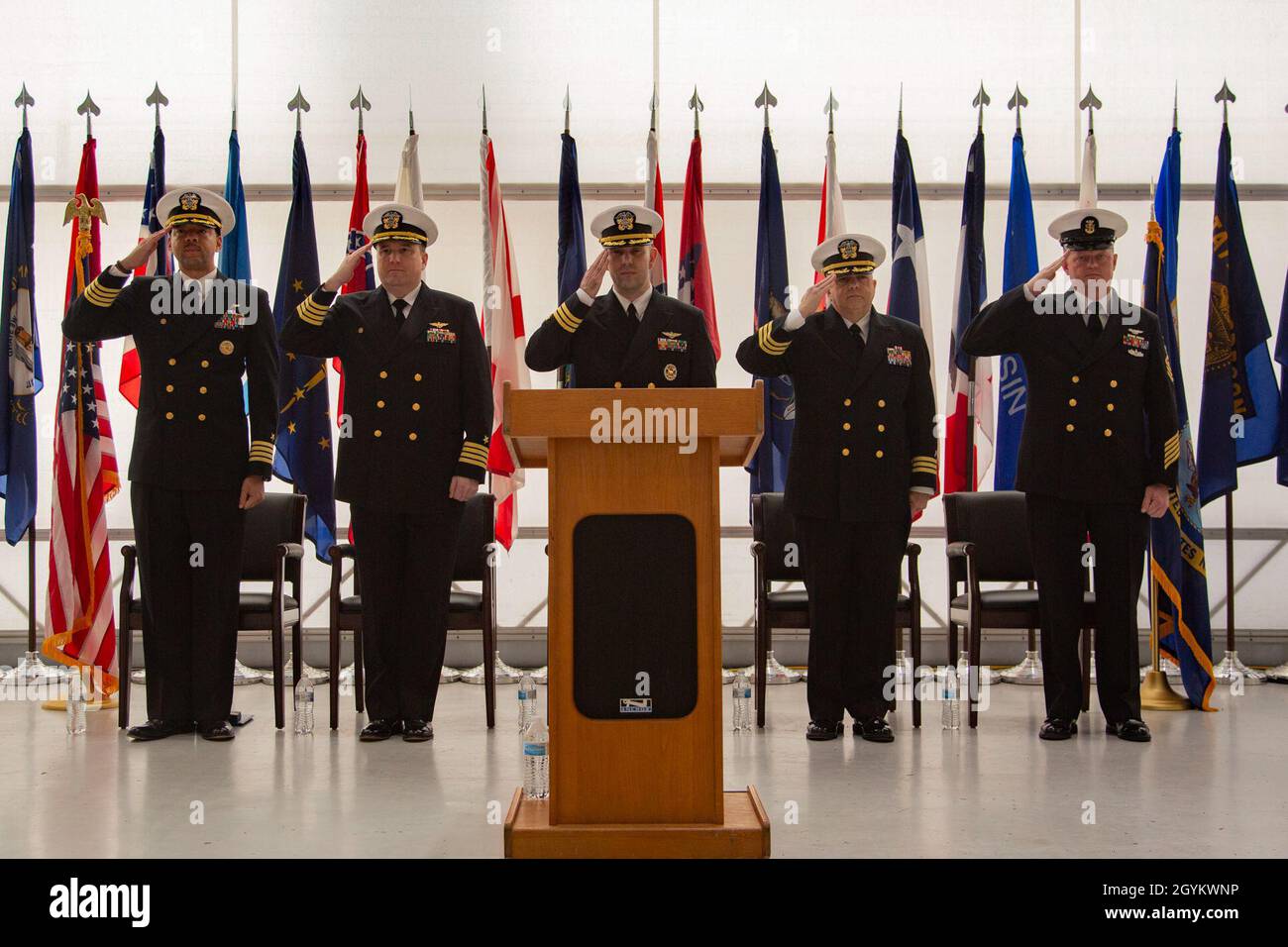 Distinguished guests salute during a change of command ceremony at the Center for Naval Aviation Technical Training hangar on Marine Corps Air Station New River, North Carolina, Jan. 23, 2020. U.S. Navy Capt. Samuel C. Bryant relinquished command of NATSG to U.S. Navy Cmdr. Cristobal Yera. (U.S.Marine Corps photo by Lance Cpl. Ginnie Lee) Stock Photo