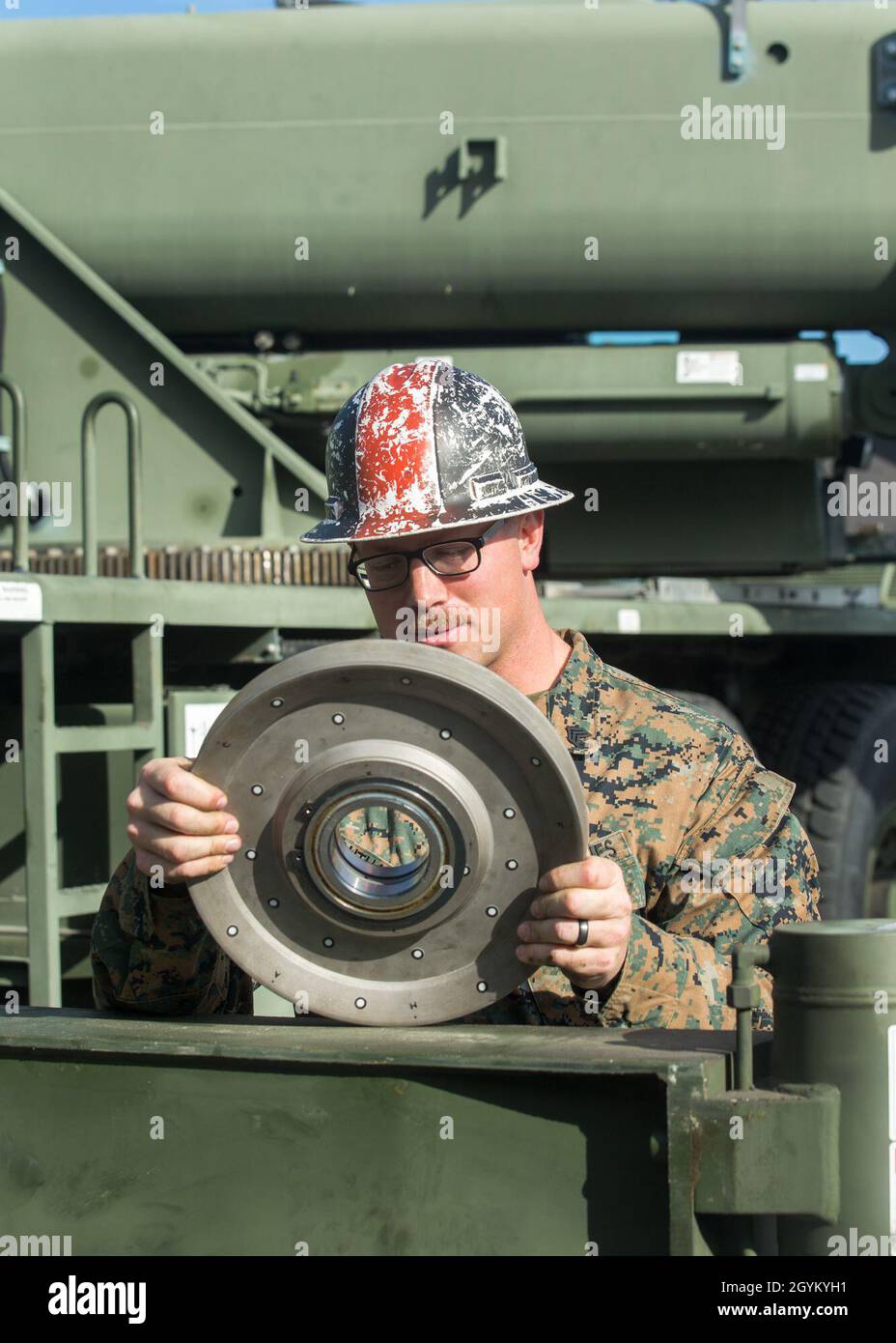 U.S. Marine Corps Sgt. Stephen Southard, a heavy equipment operator with 1st Transportation Support Battalion, 1st Marine Logistics Group, examines a 3D-printed sheave during a load test at Marine Corps Base Camp Pendleton, California, Jan. 24, 2019. The test was part of an experiment to see if 3-dimentional printing can be a suitable form of manufacturing for supply-chain replacement. (U.S. Marine Corps photo by Cpl. L. Ruth Wheeley) Stock Photo