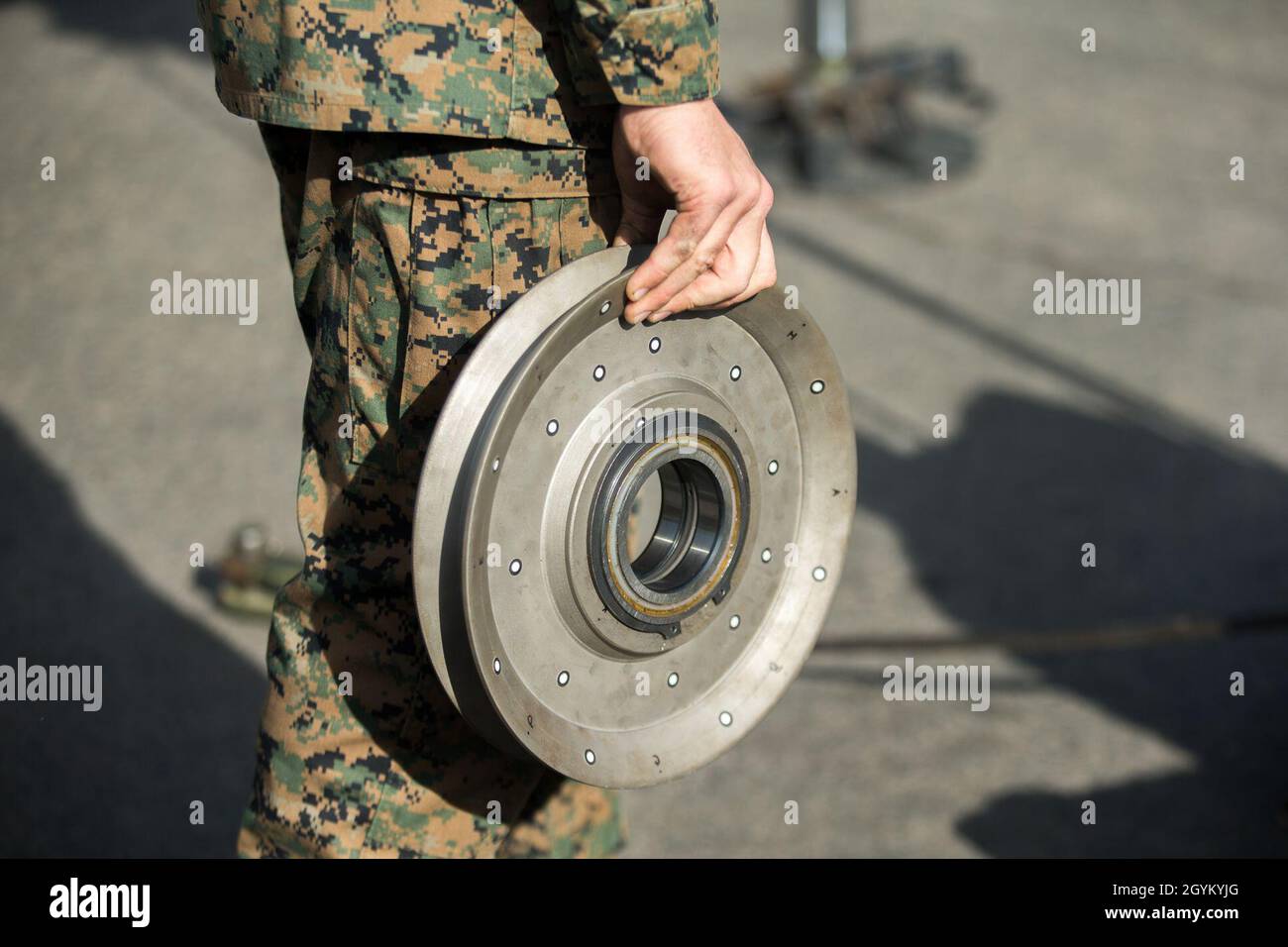 U.S. Marine Corps Sgt. Stephen Southard, a heavy equipment operator with 1st Transportation Support Battalion, 1st Marine Logistics Group, carries a 3D-printed sheave during a load test at Marine Corps Base Camp Pendleton, California, Jan. 24, 2019. The test was part of an experiment to see if 3-dimentional printing can be a suitable form of manufacturing for supply-chain replacement. (U.S. Marine Corps photo by Cpl. L. Ruth Wheeley) Stock Photo