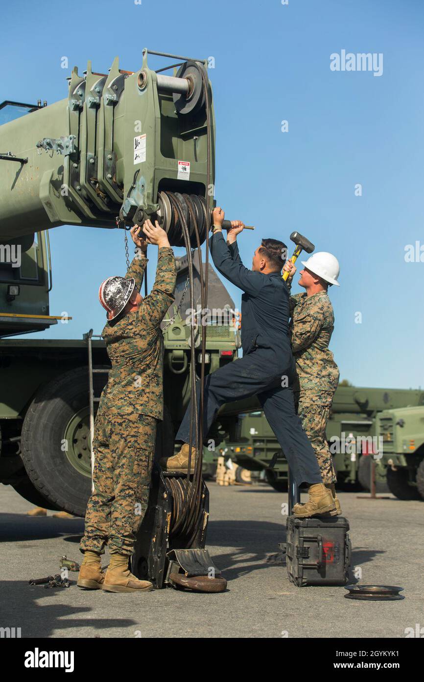 U.S. Marines with 1st Transportation Support Battalion, 1st Marine Logistics Group, install a 3D-printed sheave onto a Military All-Terrain Crane (MAC-50) during a load test at Marine Corps Base Camp Pendleton, California, Jan. 24, 2019. The test was part of an experiment to see if 3-dimentional printing can be a suitable form of manufacturing for supply-chain replacement. (U.S. Marine Corps photo by Cpl. L. Ruth Wheeley) Stock Photo