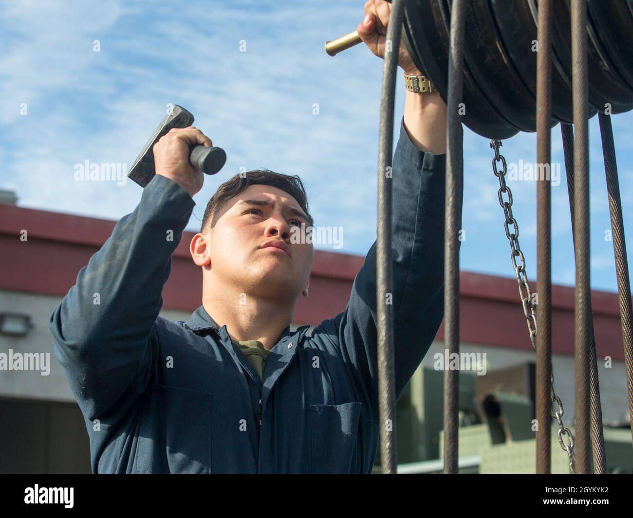 U.S. Marine Corps Lance Cpl. Xavier Garcia, a heavy equipment operator with 1st Transportation Support Battalion, 1st Marine Logistics Group, removes a sheave from a Military All-Terrain Crane (MAC-50) during a load test at Marine Corps Base Camp Pendleton, California, Jan. 24, 2019. The test was part of an experiment to see if 3-dimentional printing can be a suitable form of manufacturing for supply-chain replacement. (U.S. Marine Corps photo by Cpl. L. Ruth Wheeley) Stock Photo