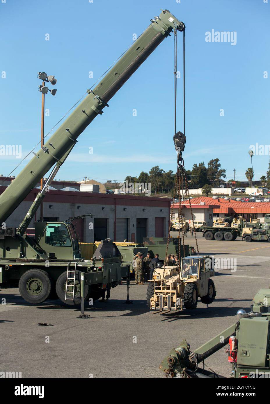 A U.S. Military All-Terrain Crane (MAC-50) belonging to 1st Transportation Support Battalion, 1st Marine Logistics Group, suspends a forklift during the testing of a 3D-printed sheave at Marine Corps Base Camp Pendleton, California, Jan. 24, 2019. The test was part of an experiment to see if 3-dimentional printing can be a suitable form of manufacturing for supply-chain replacement. (U.S. Marine Corps photo by Cpl. L. Ruth Wheeley) Stock Photo