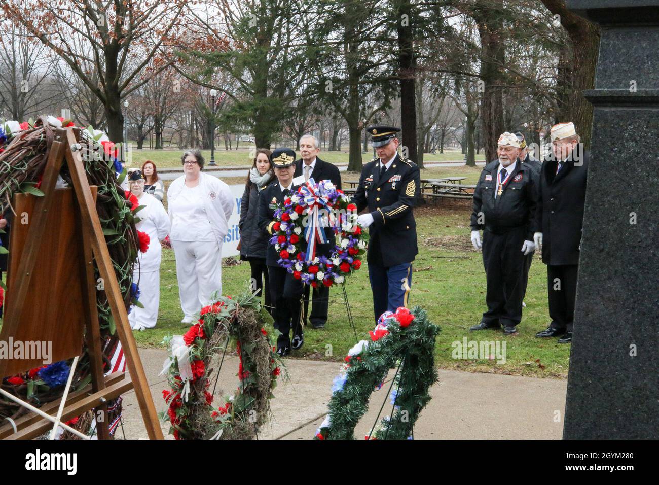 CANTON, Ohio – Brigadier Gen. Cheryn Fasano, center left, commander of the 310th Expeditionary Sustainment Command, and Command Sgt. Maj. Keith Gwin, center right, senior enlisted advisor, 310th ESC, prepare to place a wreath on behalf of President Donald J. Trump during a ceremony honoring the 25th President of the United States, William McKinley, Jan. 25, 2020, in Canton, Ohio. The annual ceremony features eight separate wreaths honoring different aspects of the life and service of McKinley, who served as president from 1897 until his assassination in 1901. Prior to that, McKinley was a Sold Stock Photo