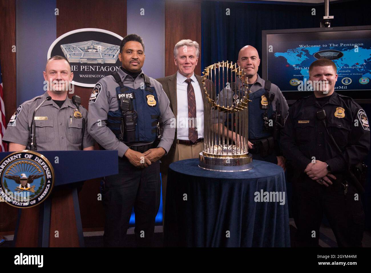 Principal Deputy Assistant to the Secretary of Defense for Public Affairs Charles E. Summers Jr. and Pentagon Police Officers pose with the Washington Nationals' 2019-2020 World Series Cup, at the Pentagon, Washington, D.C., Jan. 27, 2020. (DoD photo by Navy Petty Officer 2nd Class James K. Lee) Stock Photo