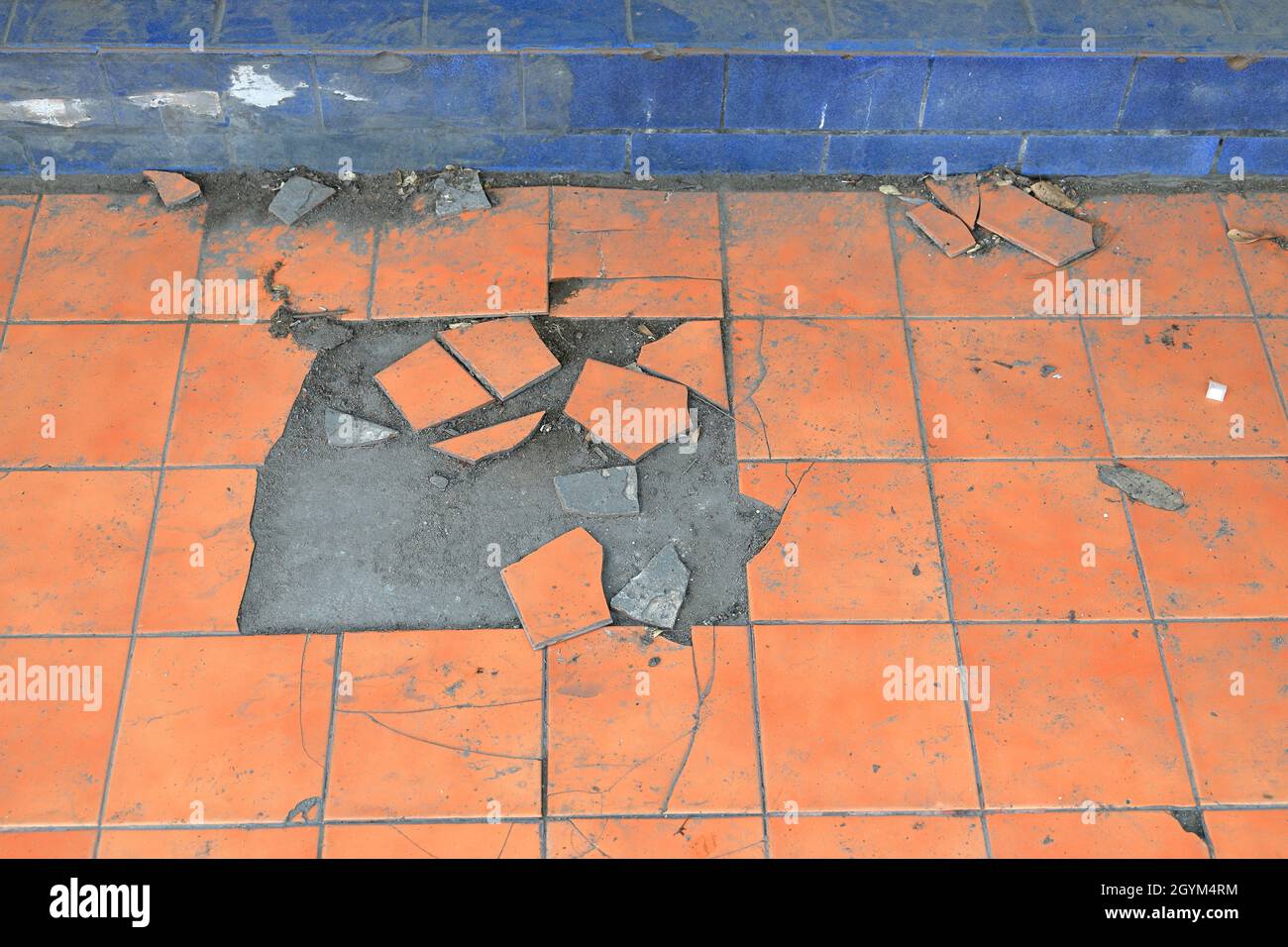 Old and broken floor tiles, Close up of a cracked ceramic tiles, floor