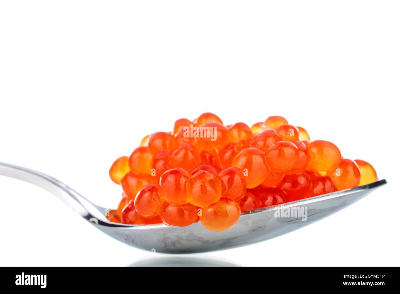 Lightly salted red chum salmon caviar with a metal spoon, close-up, isolated on white. Stock Photo