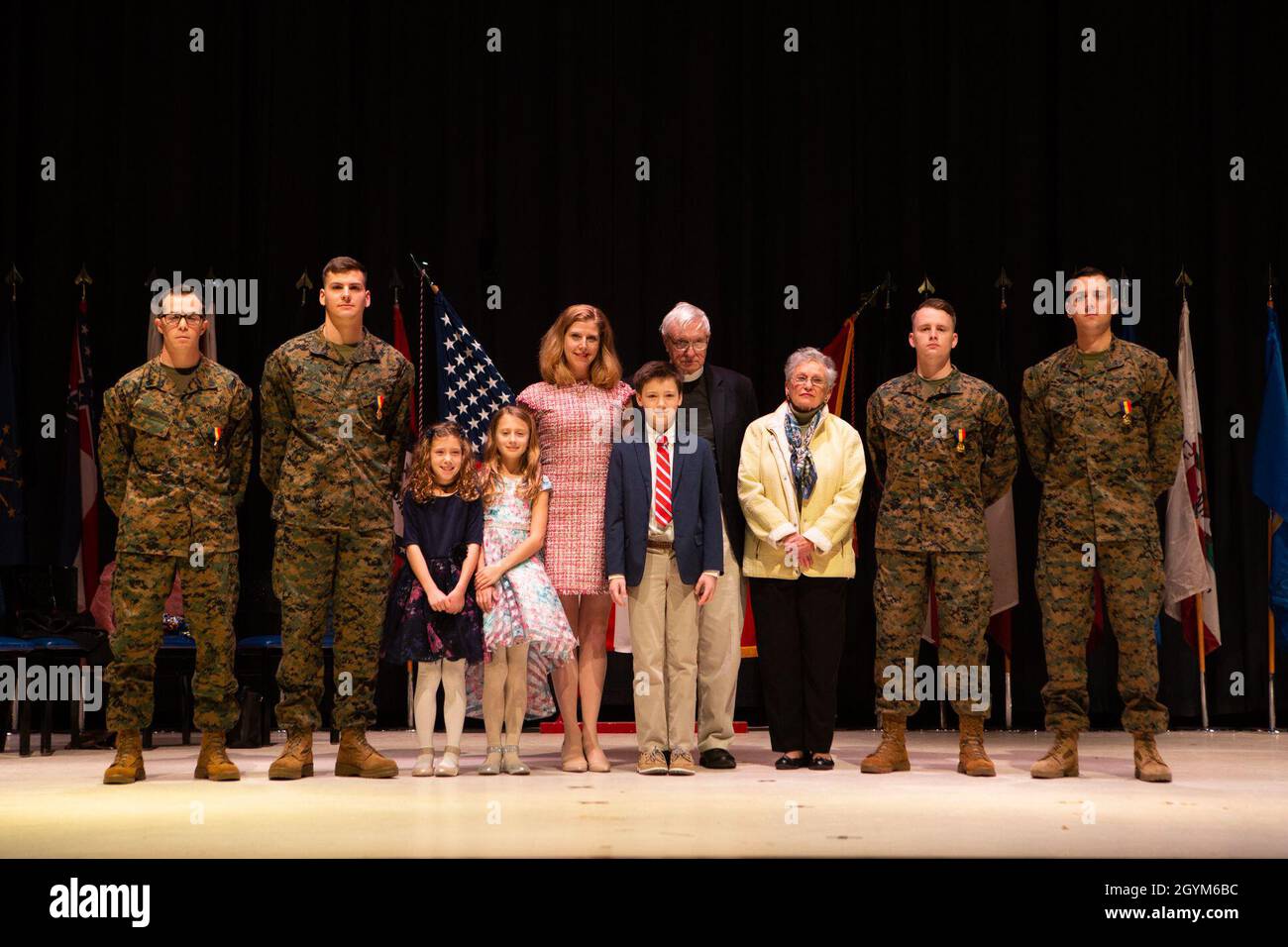 Staff Sgt. Leary Reicharwarfel (left), Sgt. Anders Larson, Cpl. Austin McMullen, and Cpl. Timothy Watson pose for a photo with the family they saved after receiving the Navy and Marine Corps Medal aboard Marine Corps Air Station Cherry Point, North Carolina, January 28, 2019. The Marines received this award for his heroic efforts while saving a family at Atlantic Beach, North Carolina. (U.S. Marine Corps photo by Staff Sgt. William L. Holdaway) Stock Photo