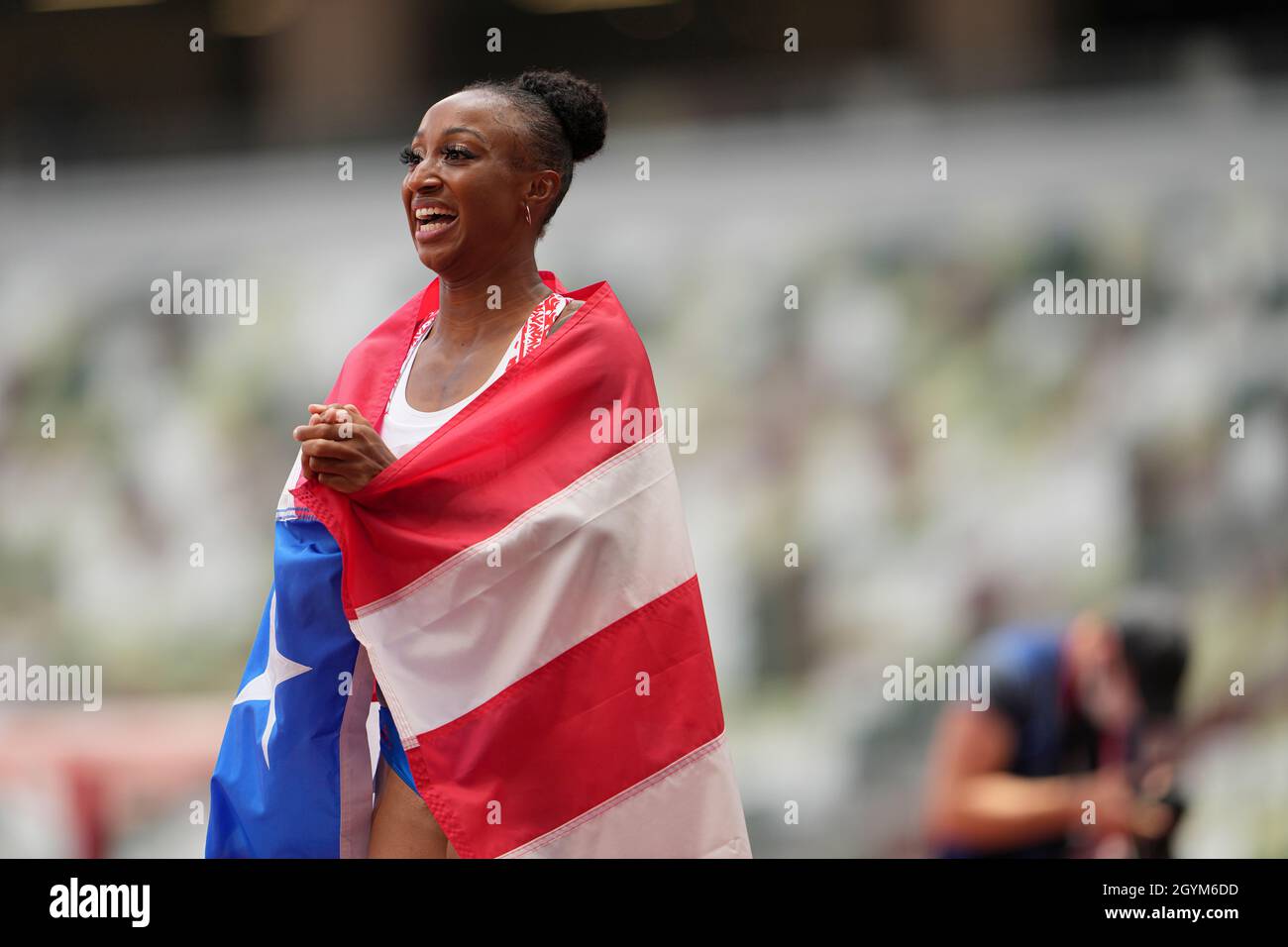 Jasmine CamachoQuinn with her country's flag after winning gold at the