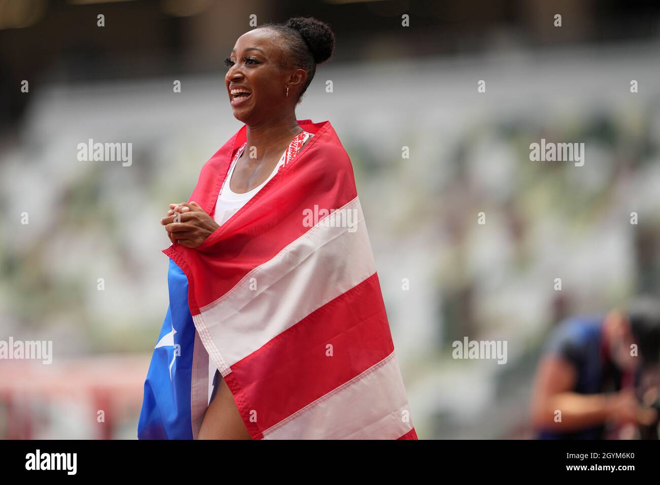 Jasmine CamachoQuinn with her country's flag after winning gold at the