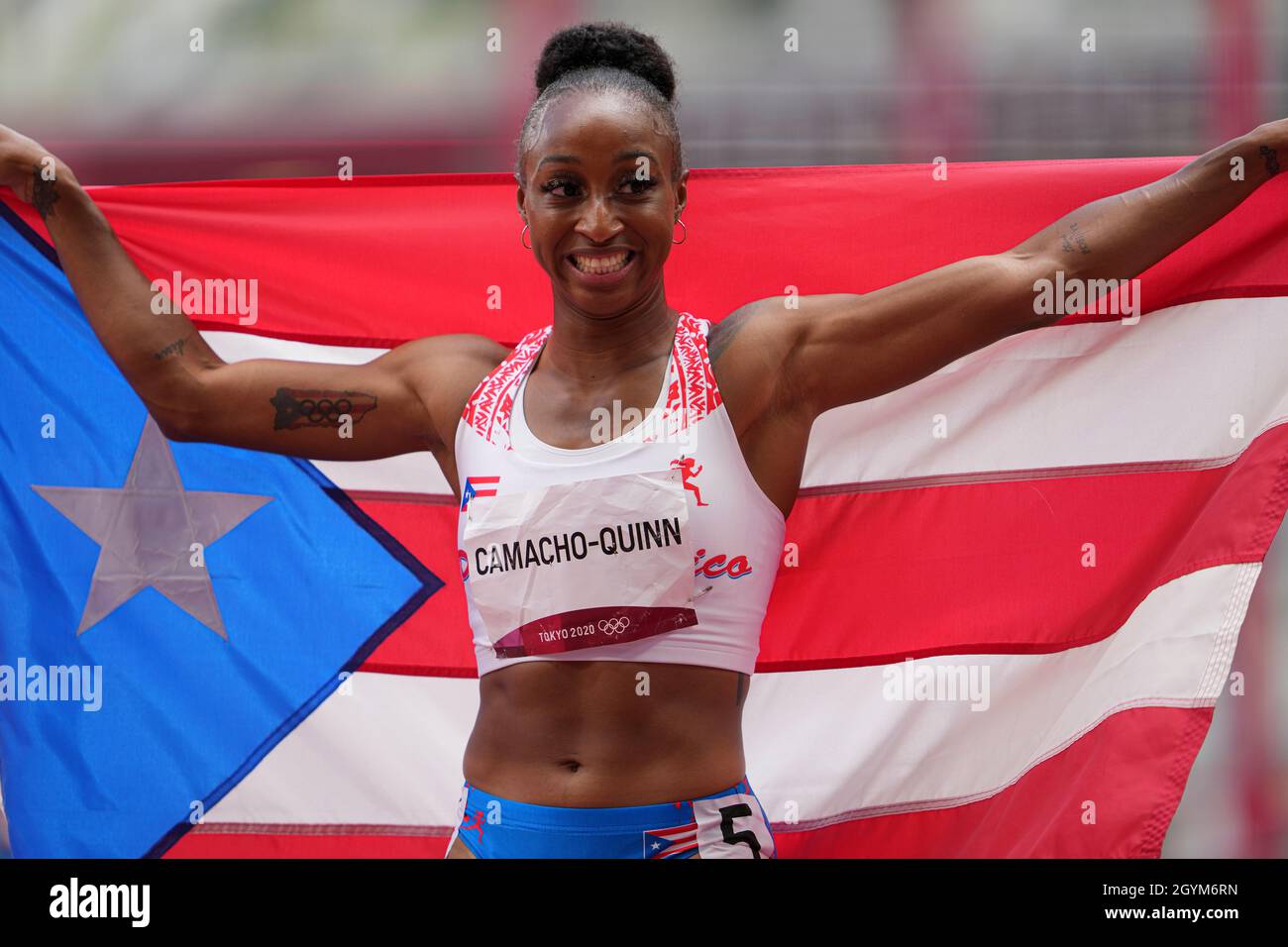 Jasmine CamachoQuinn with her country's flag after winning gold at the