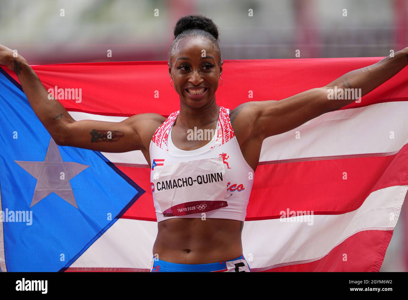 Jasmine CamachoQuinn with her country's flag after winning gold at the