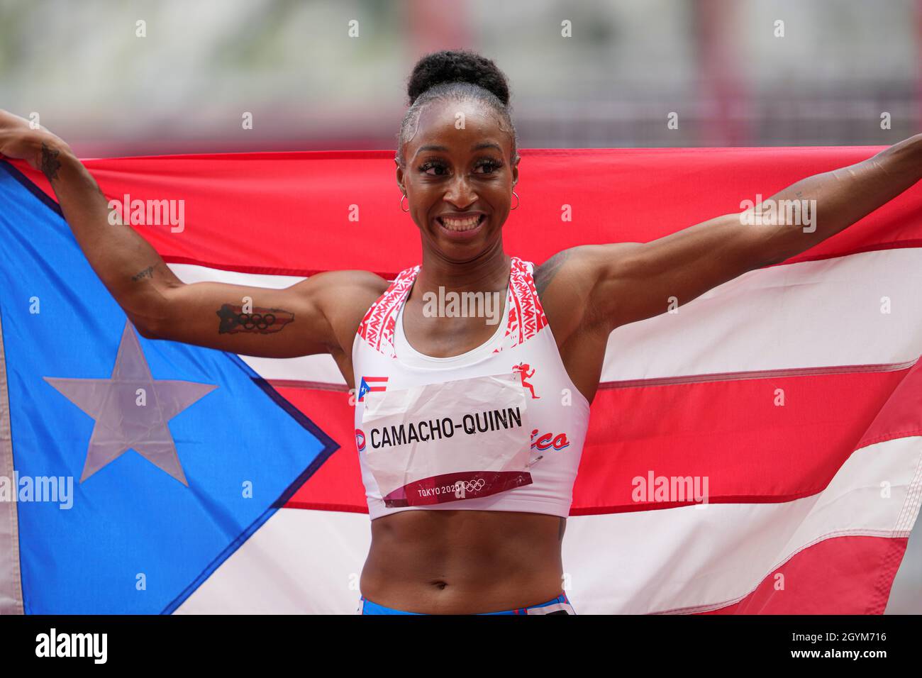 Jasmine CamachoQuinn with her country's flag after winning gold at the