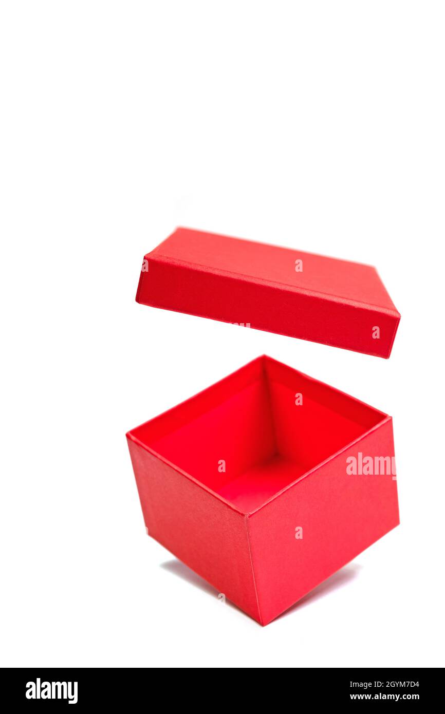 Red cardboard box with opened lid against white background Stock Photo