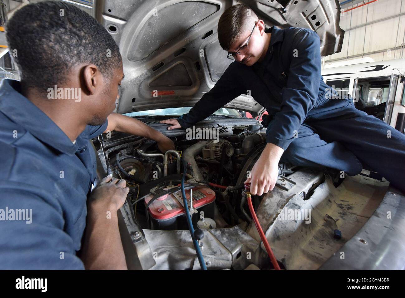 Airmen with the 379th Expeditionary Logistics Readiness Squadron perform maintenance on a vehicle at Al Udeid Air Base, Qatar on Jan. 28, 2020. The 379 ELRS maintains a fleet of more than 2,500 vehicles. (U.S. Air Force photo by Tech. Sgt. John Wilkes) Stock Photo