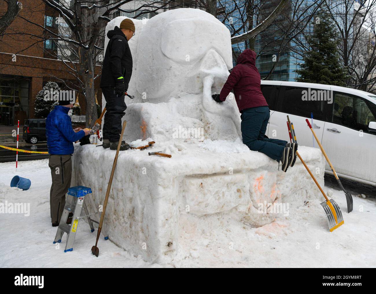 200129-N-EJ241-1076    SAPPORO, Japan (Jan. 29, 2020) - Sailors from Naval Facilities Engineering Command Far East, Misawa Detatchment, and Commander, Task Force 72 sculpt a snow statue during the 71st Annual Sapporo Snow Festival. This is the 37th year the U.S. Navy has participated in the festival, allowing Sailors a unique opportunity to experience Japanese culture and tradition while strengthening the close friendship between the U.S. Navy and the citizens of Japan. (U.S. Navy photo by Mass Communication Specialist 3rd Class Jan David De Luna Mercado) Stock Photo