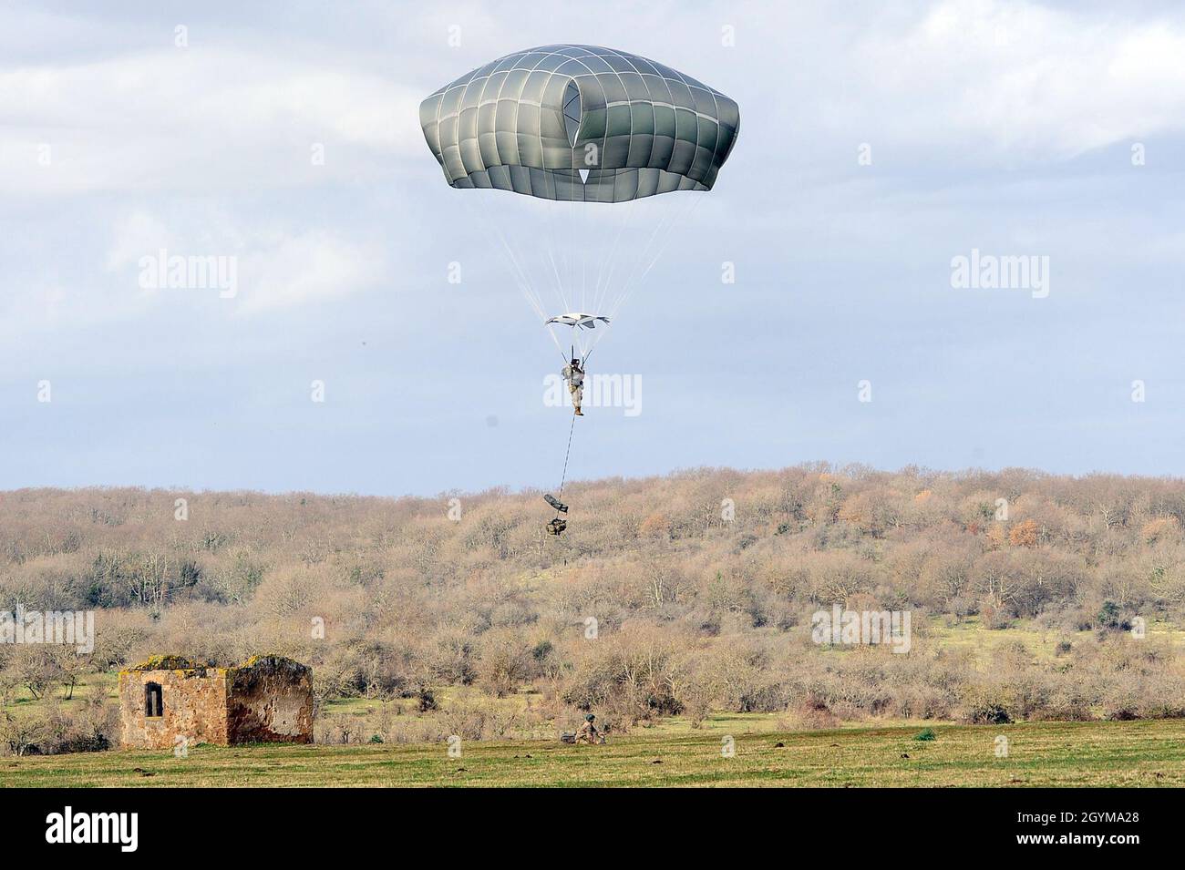 A U.S. Army paratrooper from HHC, 2nd Battalion, 503rd  Infantry Regiment, 173rd Airborne Brigade jumps during the  Exercise Rock Topside 20, at Monte Romano Italian training area, Monte Romano, Italy, Jan. 29, 2020. Rock Topside is a joint forced entry exercise to train the battalion’s ability to conduct airborne contingency response force operations. This training stresses the interoperability of both the paratroopers of the 2nd Battalion, 503rd Infantry Regiment and Italian paratroopers of Reggimento Savoia Cavalleria 3. (U.S Army photo by Elena Baladelli) Stock Photo