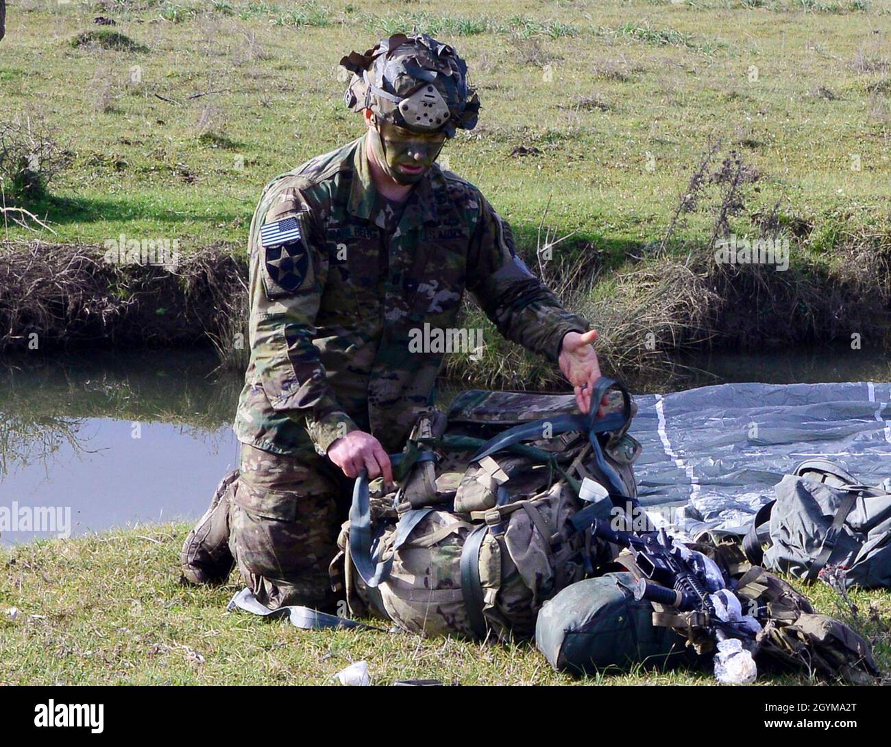A U.S. Army paratrooper from HHC, 2nd Battalion, 503rd  Infantry Regiment, 173rd Airborne Brigade recovers his parachute after the airborne operation  during Exercise Rock Topside 20, Monte Romano, Italy, Jan. 29, 2020.Rock Topside is a joint forced entry exercise to train the battalion’s ability to conduct airborne contingency response force operations. This training stresses the interoperability of both the paratroopers of the 2nd Battalion, 503rd Infantry Regiment and Italian paratroopers of Reggimento Savoia Cavalleria 3. (U.S Army photo by Elena Baladelli) Stock Photo