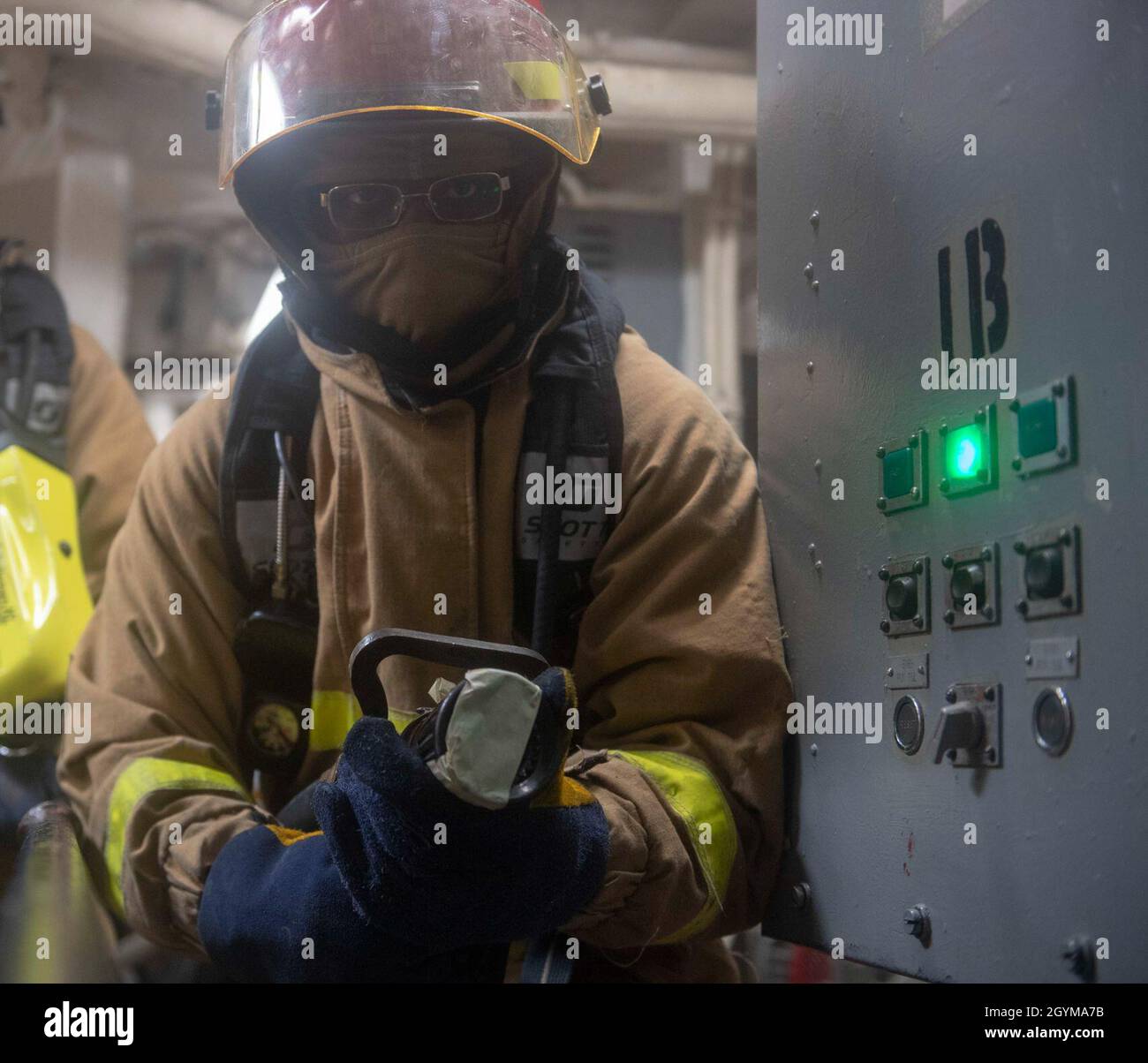 PACIFIC OCEAN (Jan. 29, 2020) Damage Controlman 3rd Class Tyler J. Greer, from Beaumont, Texas, fights a simulated fire during a general quarters drill aboard the Arleigh Burke-class guided-missile destroyer USS Paul Hamilton (DDG 60) Jan. 29, 2020. Paul Hamilton, part of the Theodore Roosevelt Carrier Strike Group, is on a scheduled deployment to the Indo-Pacific. (U.S. Navy photo by Mass Communication Specialist 3rd Class Matthew F. Jackson) Stock Photo