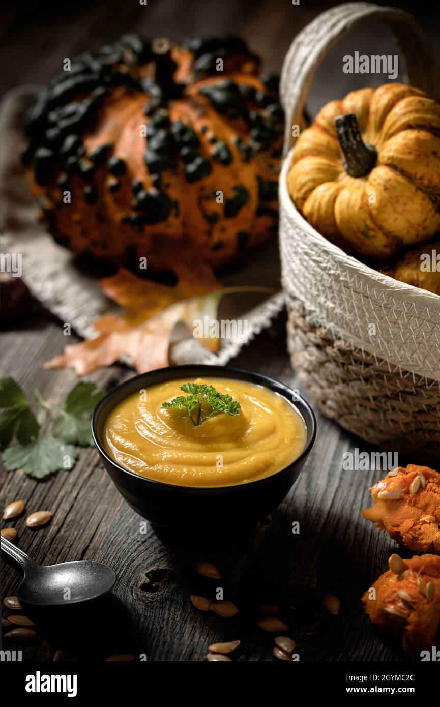 delicious autumn pumpkin soup on wooden table Stock Photo
