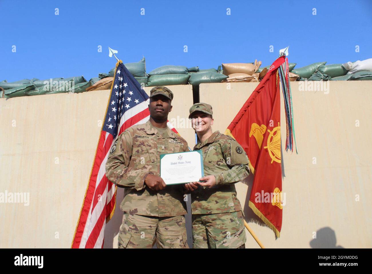 Maj. Patrick Smith, 840th Transportation Battalion, and Sgt. Ahslee S. Heckler, 840th Trans. Bn., pose with her certificate of reenlistment following her ceremony at Camp Arifjan, Kuwait, Jan. 31, 2020. (U.S. Army photo by Claudia LaMantia) Stock Photo