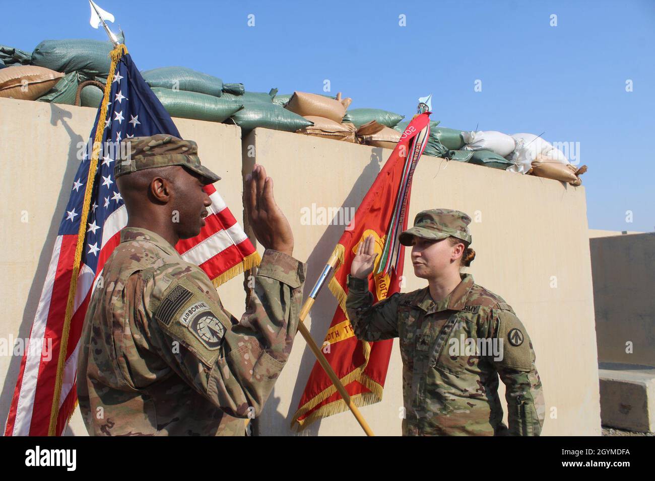 Maj. Patrick Smith, 840th Transportation Battalion, administers the oath of enlistment to Sgt. Ashlee S. Heckler, 840th Trans. Bn., during a ceremony at Camp Arifjan, Kuwait, Jan. 31, 2020. (U.S. Army photo by Claudia LaMantia) Stock Photo