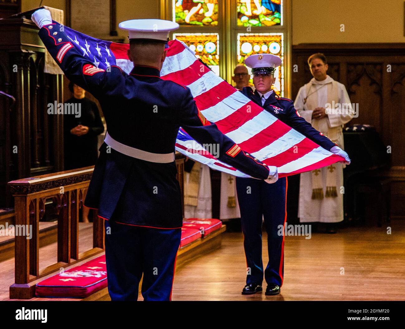 Marines with Marine Forces Reserves present the American flag at the memorial service of Brooke Helm Duncan at The Trinity Episcopal Church, New Orleans, Feb. 1, 2020. Mr. Duncan was a retired Corsair pilot for the United States Marine Corps and an Active civic leader in his community. (U.S. Marine Corps photo by Lance Cpl. Samwel Tabancay) Stock Photo